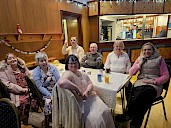 A table of seven smiling dancers