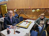 Two dancers sitting at a table enjoying watching