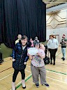 Ellie presenting Gina with certificate