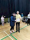 Ellie presenting Roy with certificate