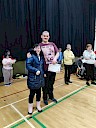 Ellie presenting Neil with certificate