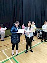 Ellie presenting Becca with certificate