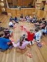 Children sitting in a big circle opening presents