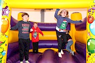 Four children bouncy in the bouncy castle