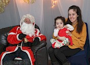 A toddler and their mum getting a photo with santa