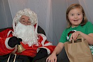 A child getting a present from Santa