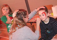 A child having their face painted