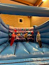 3 children bouncing in the bouncy castle