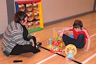A child playing with toys on the floor