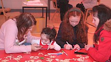 Four people making Christmas arts and crafts